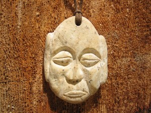 Carved beachstone Buddha face. 